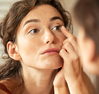 A woman putting in a contact lens