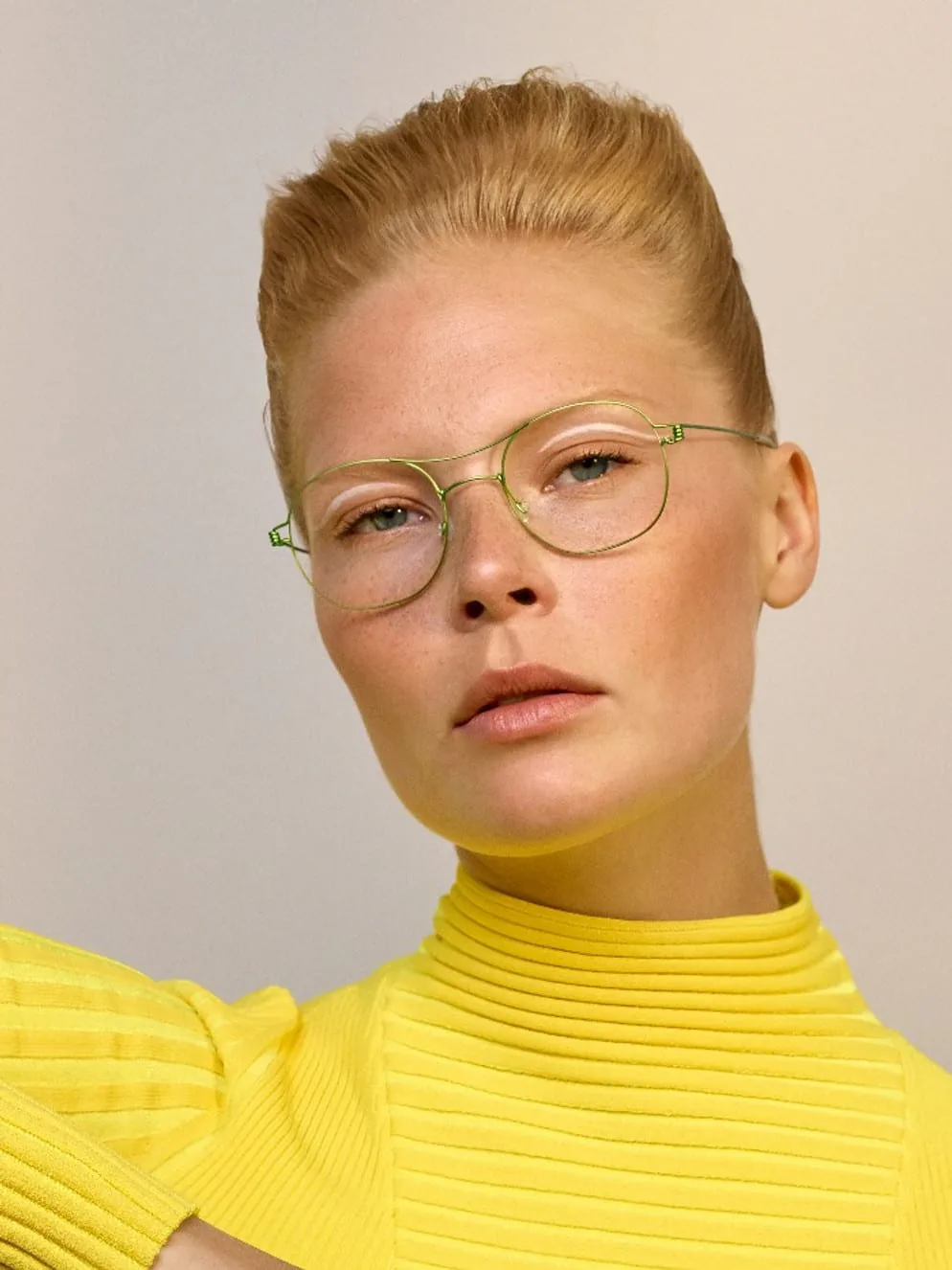 A woman wearing round Lindberg glasses