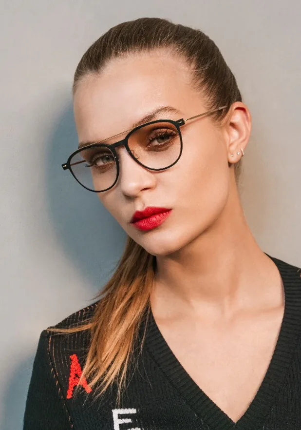A woman wearing Lindberg cat-eye glasses