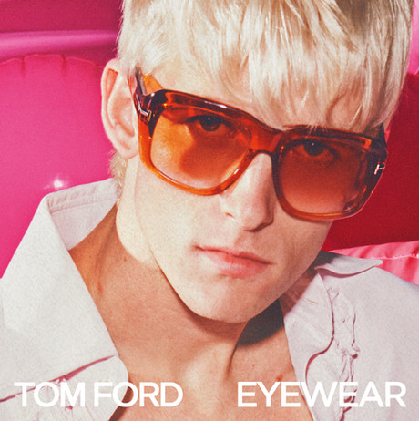 A model wearing Tom Ford sunglasses with orange lenses