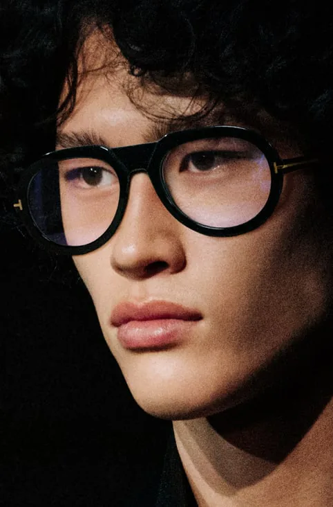 A model wearing round black glasses