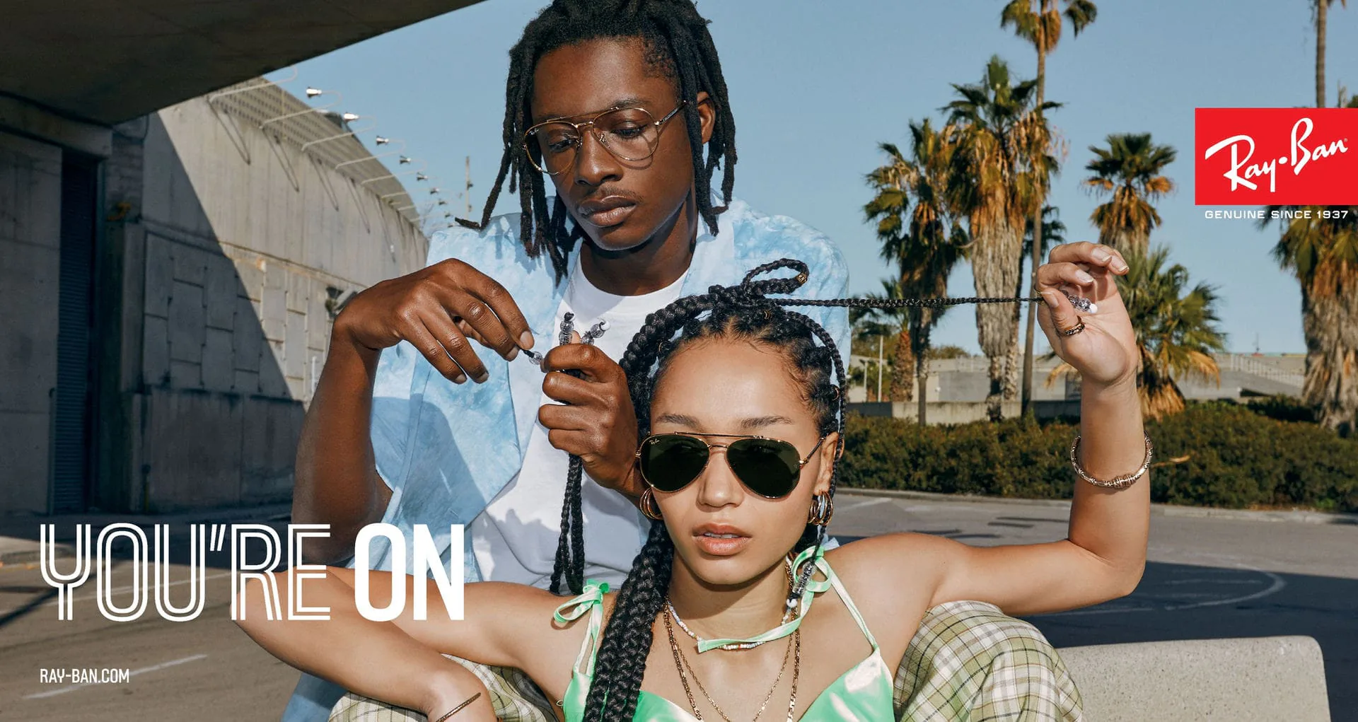 A Ray-Ban campaign image of two people wearing sunglasses, captioned You're On