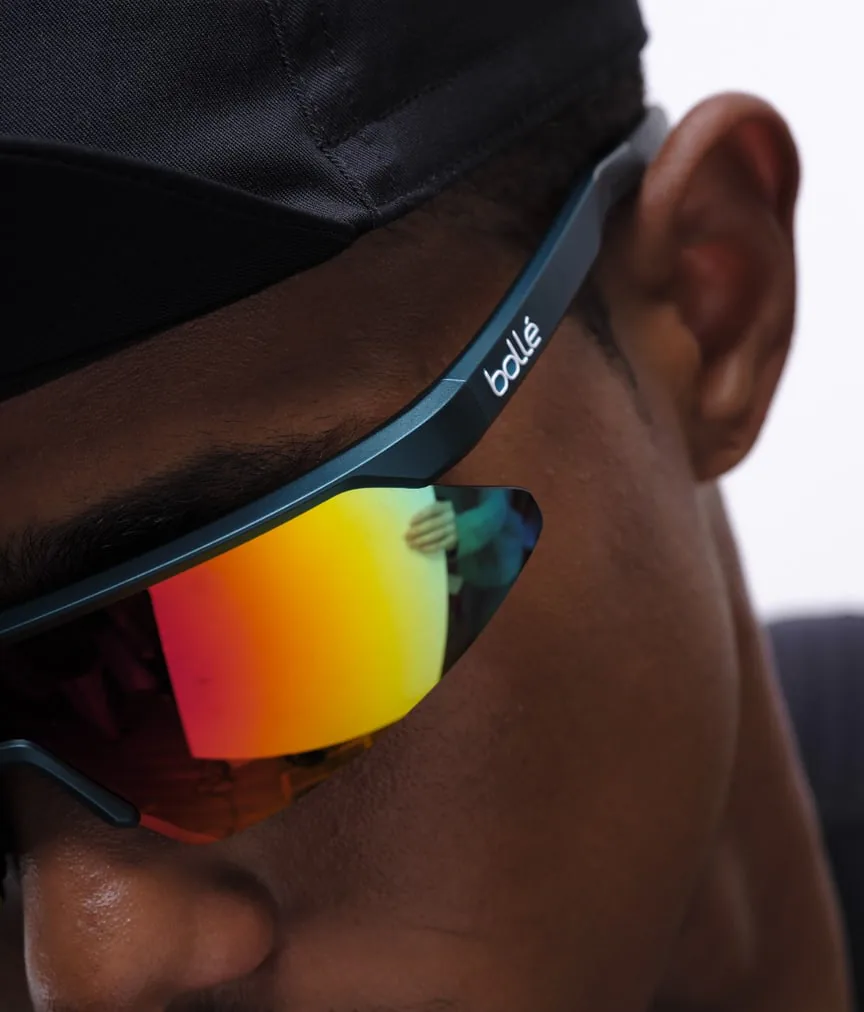A close-up of wraparound sports sunglasses with mirrored lenses