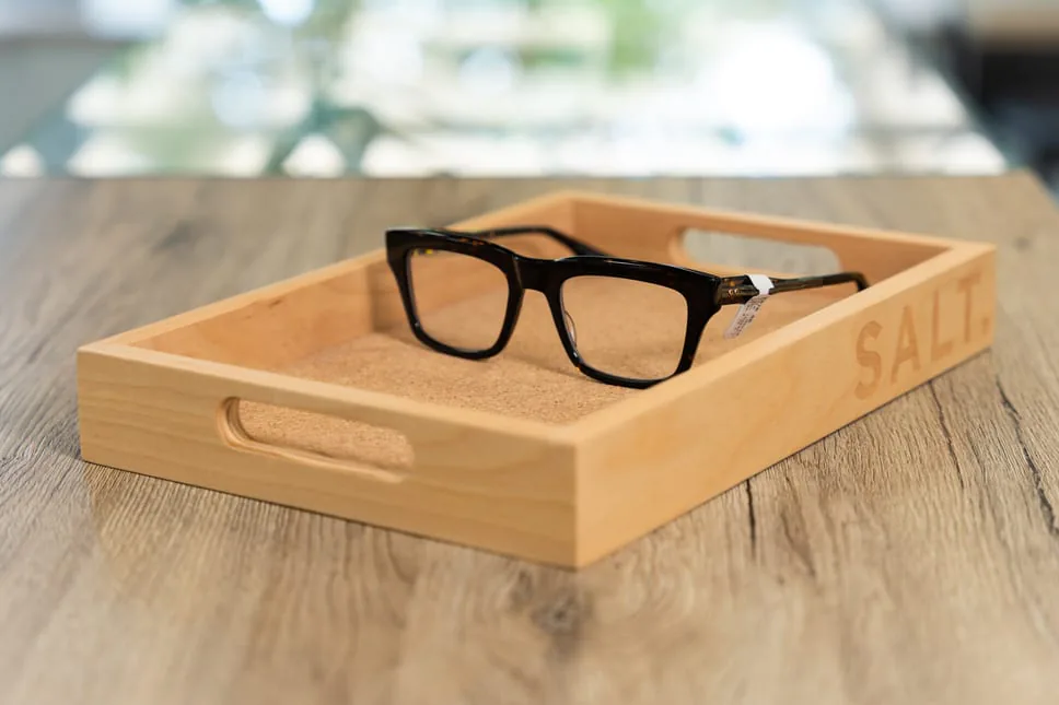 Glasses resting on a wooden display tray